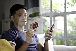 Asia man shopping and easy and convenient payment using credit card with online payment and banking application on smartphone