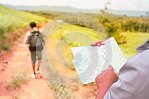 Asia man Traveler man with map backpack.