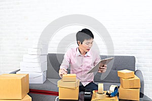 Asia man working business SME online at home.