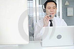 asia man working call center operator with headset in office or workplace