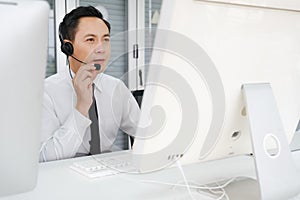 asia man working call center operator with headset in office or workplace