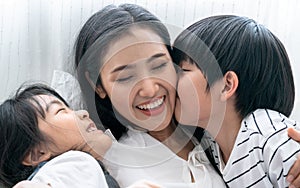 Asia mom playing with her son and daughter, They smile happily, Love, Family ties, Single Mother.