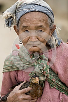 Asia, old woman with chicken