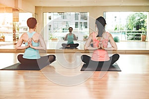 Asia people lifestyle practicing and exercising vital meditate yoga in class room.