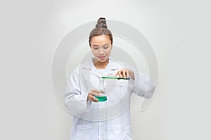 An Asia scientific researcher holding at a liquid solution in a lab