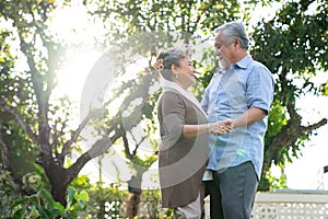 Asia senior couple, Happy retirement life, Asian couples dance together in the front garden.