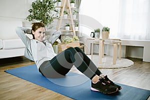 Asia woman doing exercise in her living room
