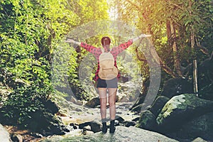 Asia woman hiker standing on forest trail outdoor and looking away. Female with backpack on hike destination and leisure in nature