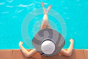 Asia woman lifestyle relaxing near luxury swimming pool sunbath, summer day at the beach resort