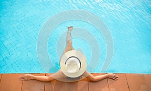 Asia woman lifestyle relaxing near luxury swimming pool sunbath, summer day at the beach resort