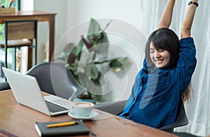 Asia woman relax after working,female raise arm up stretching in