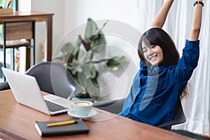 Asia woman relax after working,female raise arm up stretching in