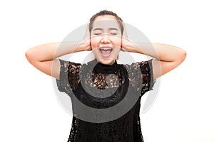 Asia woman screaming and covering ears with her hands