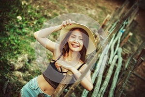 Asia woman in summer fashion posing with bamboo bridge