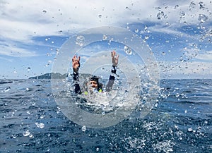 Asia woman swimming in sea and splash water to camera.Summer fun