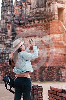 Asia woman take image ancient temple by smarth phone