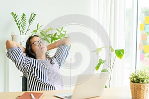 Asia woman touching massage stiff neck after sedentary computer work in incorrect posture, overworking for  long time,  exercises