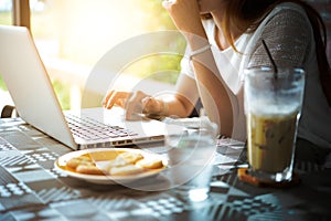 Asia woman Using Laptop In Coffee Shop