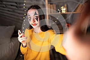 Asia women micro influencer with Halloween make-up record live video camera at home studio. girl youtuber fun talk speak