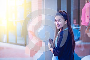 Asia women with tablet is walking in economic zones