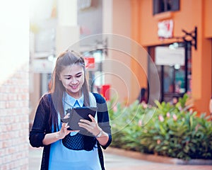 Asia women using tablet and cellphone in economic zones