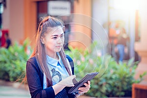 Asia women using tablet and cellphone in economic zones