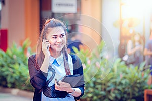 Asia women using tablet and cellphone in economic zones