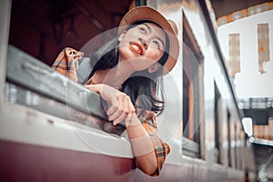 Asia young women tourists sit on the train at Hua Lamphong Station Bangkok Thailand. To Attractions on vacation