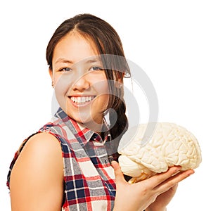 Asian 15 years old girl holding cerebrum model