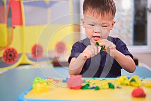 Asian 2 - 3 years old toddler boy child having fun playing colorful modeling clay / Play dough at home, Educational toys for kid