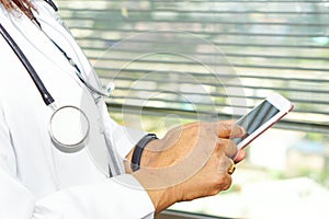 Asian active woman lady holding mobile phone to communicate about work at hospital.