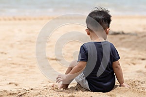 Asian adorable little kid boy having fun on tropical beach of Thailand