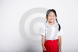Asian adorable toddler smiling happy wearing student thai uniform standing