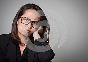 Asian adult woman boring face. Portrait of business women in black suit on white background.