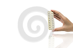 Asian adult woman hand holding pack of contraceptive pills