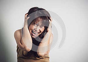 Asian adult woman screaming. Portrait on white background with d