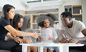 Asian-African American family relaxing, chatting, painting and having fun on vacation