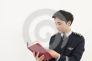 Asian Airline pilot reading a book