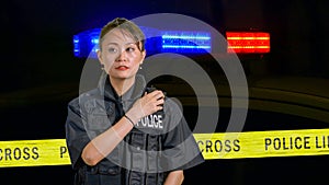 Asian American Policewoman using police radio