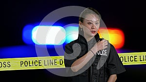 Asian American Policewoman using police radio