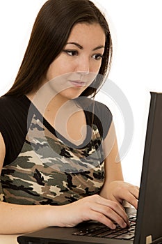 Asian American woman focused while typing on computer