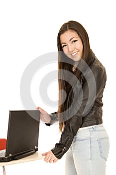 Asian American young woman standing by a computer