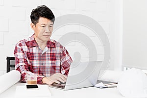 Asian architect at construction site office