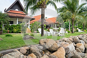 Asian architecturally designed residential properties beyond heavy rock beach wall.