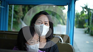 Asian Asia mother and daughter enjoying rail ride at sentosa, Singapore with mask on