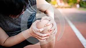 Asian athlete man suffering from knee pain