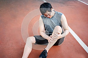 Asian athlete man suffering from leg and knee pain