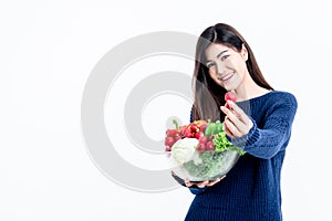 Asian attractive Woman holding glass bowl  contains fruit and fresh vegetables On white background