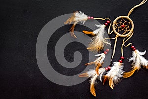 Asian attributes. Dream catcher on black background top view copy space