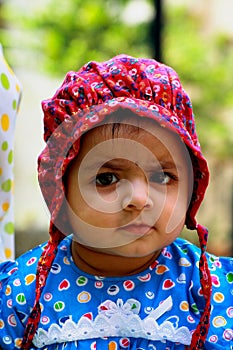 Asian baby in bonnet